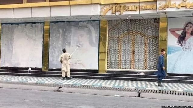 Imagem de quando talibãs assumiram o poder, homem cobre de tinta imagens de mulheres em Cabul: adoção de constituição da monarquia -  Foto: Lotfullah Najafizada/Reprodução Twitter